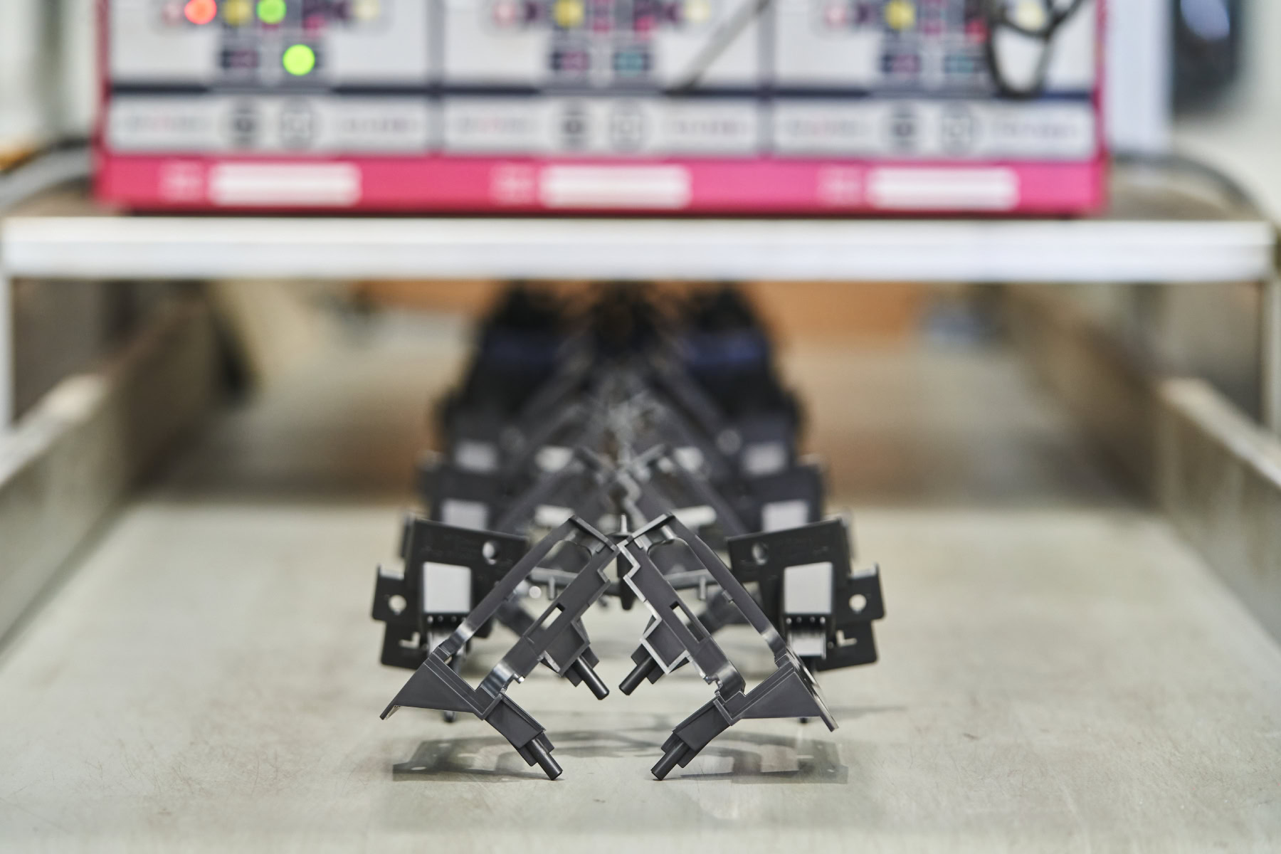 Injection moulded components on conveyor belt