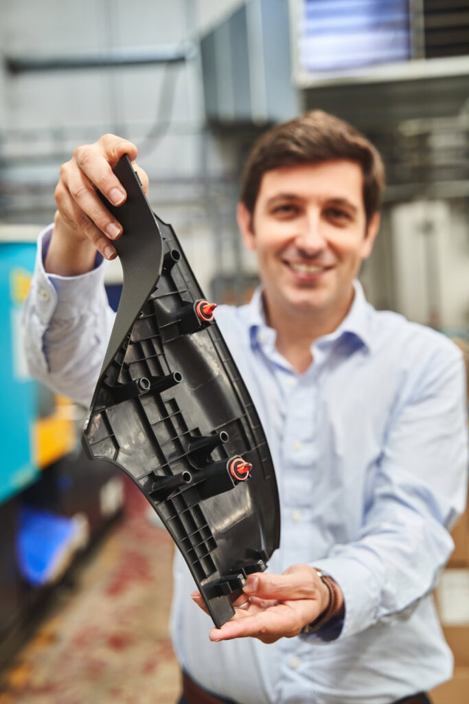 Person holding injection moulded product